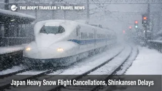 Japan heavy snow flight cancellations Shinkansen delays as a bullet train pushes through blowing snow near a station