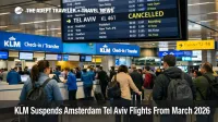 KLM Amsterdam Tel Aviv flights suspended shown on Schiphol departures board, with travelers queuing at KLM counters