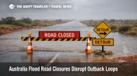 Australia flood road closures shown on an outback highway near Birdsville with water over road and a closure sign