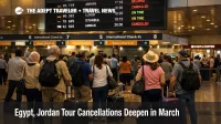 Egypt Jordan tour cancellations reflected in a busy Cairo airport departures hall as travelers wait with luggage
