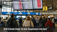 KLM Middle East suspensions shown on Schiphol departure boards as travelers queue for rebooking help