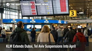 KLM Middle East suspensions shown on Schiphol departure boards as travelers queue for rebooking help