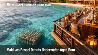 Maldives underwater-aged rum experience at NH Collection Reethi with submerged bottle cage visible below clear lagoon water