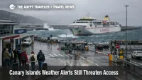 Canary Islands weather alerts at a Tenerife ferry terminal show rough seas, wet access, and delayed island transfers
