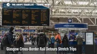 Travelers check boards at Glasgow Central during cross-border rail detours that are stretching Scotland journeys