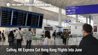 Cathay Hong Kong flight cuts shown by travelers checking departures at Hong Kong International Airport before June trips